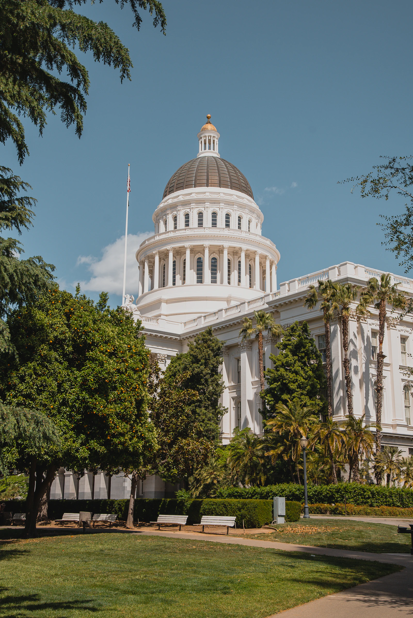 California Capitol building with state flag